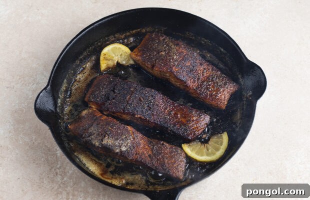 Blackened salmon filets in cast iron skillet