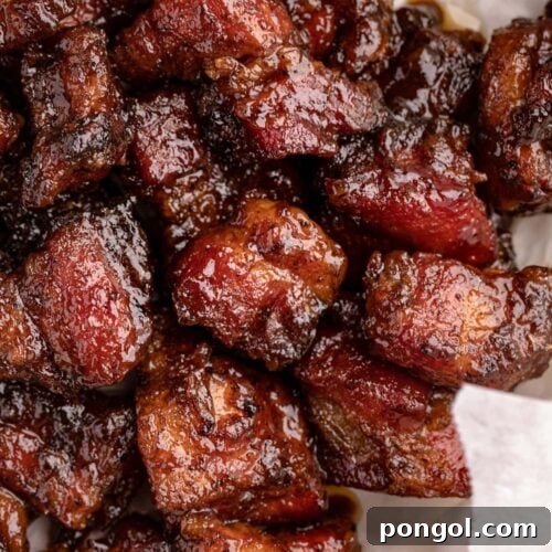 Pork belly burnt ends in a white bowl, ready to be served.