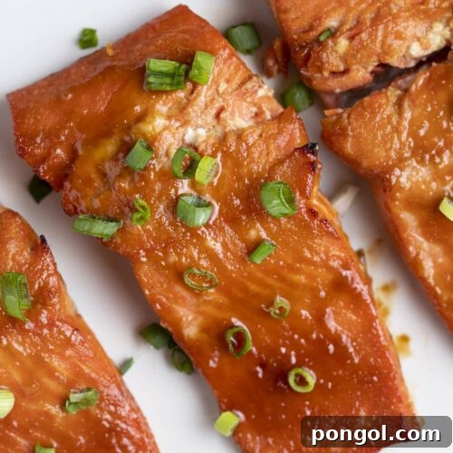 Perfect Miso Glazed Salmon 4 Three miso salmon fillets on a white plate, ready to be served.