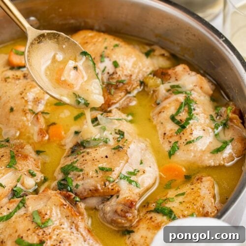 chicken fricassee in a skillet with a spoon