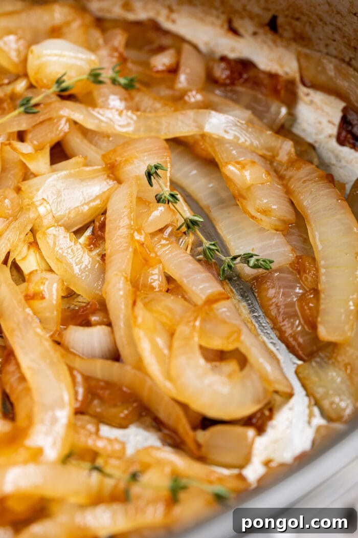 close up image of sauteed onions with fresh thyme