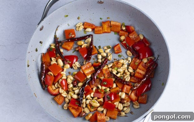 Bell pepper and peanuts in large skillet