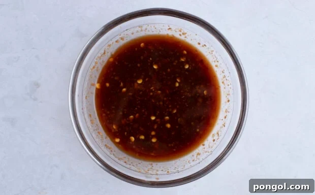 Kung pao beef sauce in large glass mixing bowl