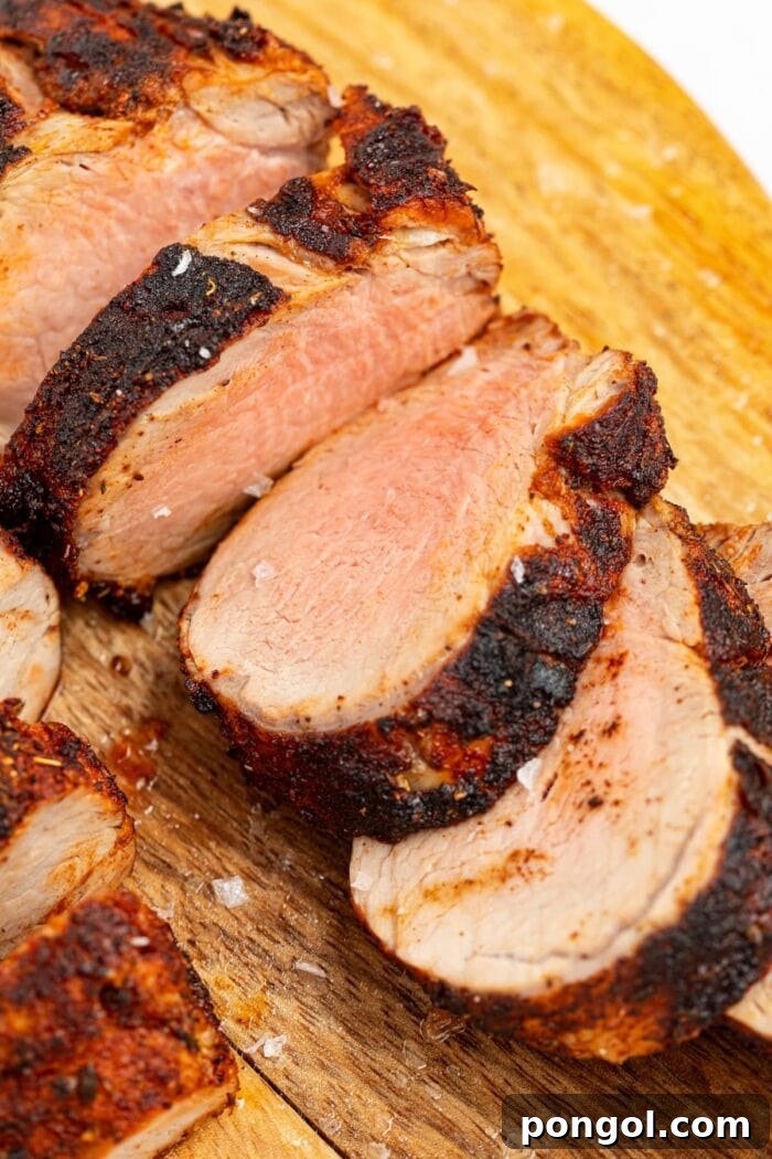 sliced air fryer pork tenderloin on a cutting board