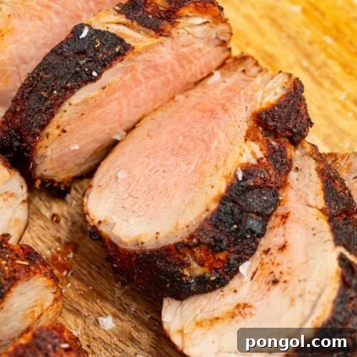 sliced air fryer pork tenderloin on a cutting board