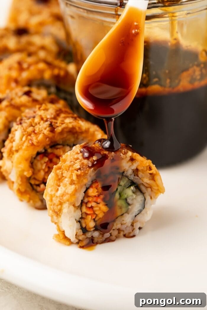 Sweet Unagi Glaze 2 Eel sauce drizzled generously over pieces of sushi on a pristine white plate, showcasing its rich, dark glaze and appetizing presentation.