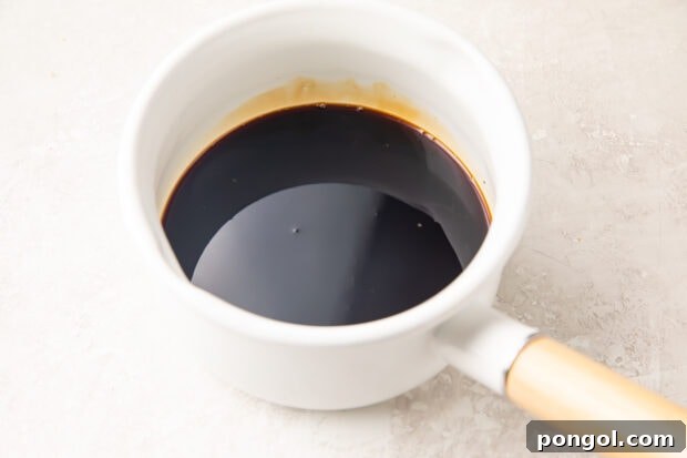 Sweet Unagi Glaze 6 Eel sauce ingredients combining in a small white saucepan, ready for cooking