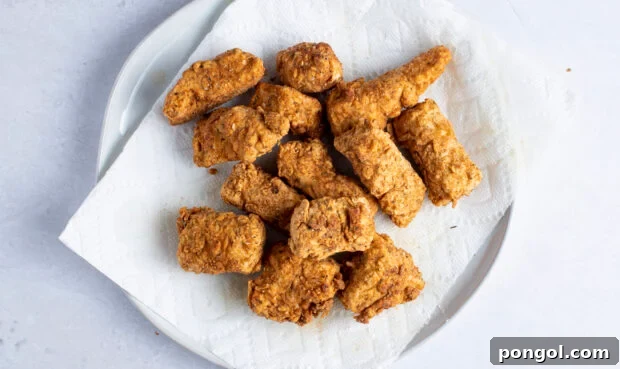 Vegan Fried Tofu Chik'n 10 Vegan fried chicken on white plate with paper towel