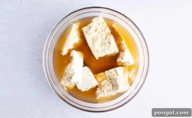 Vegan Fried Tofu Chik'n 6 Tofu in glass bowl with vegetable broth