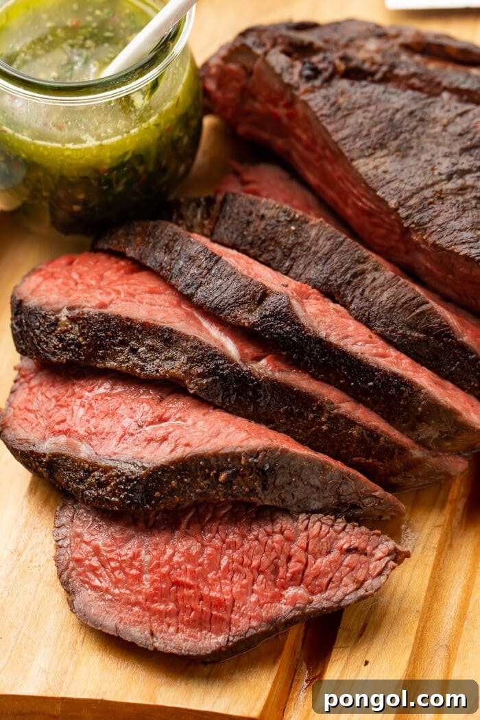 Sous vide tri tip on a cutting board, ready to be sliced