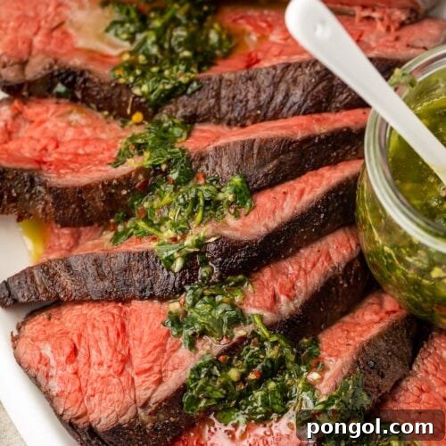 Sous vide tri tip close up with vibrant chimichurri sauce