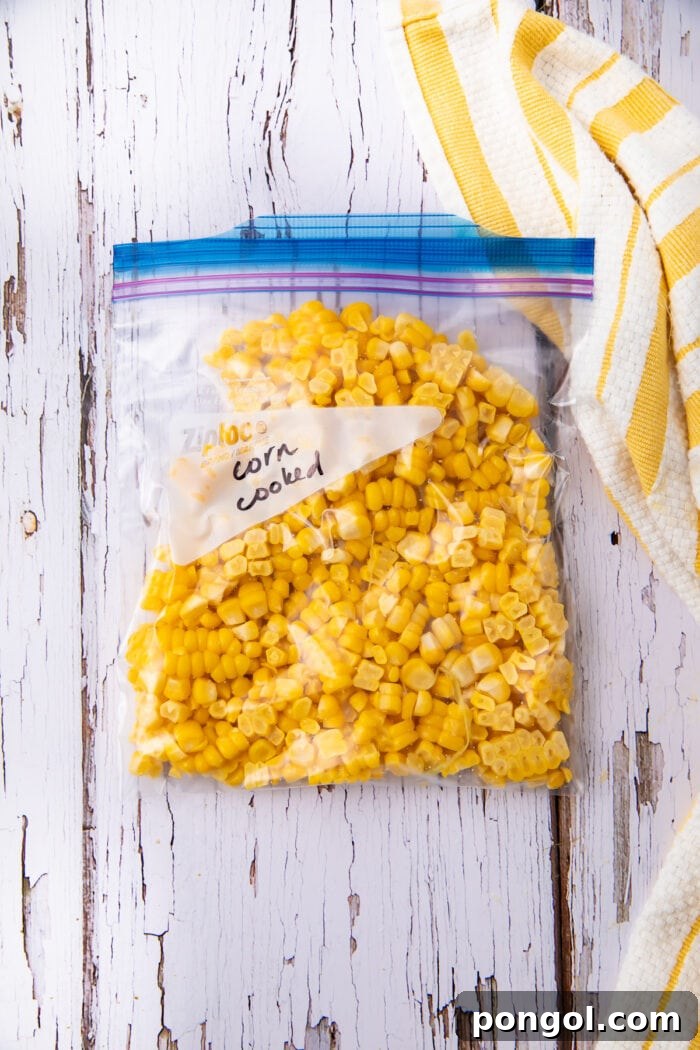 Cooked corn kernels in freezer bag, clearly labeled and ready for storage.