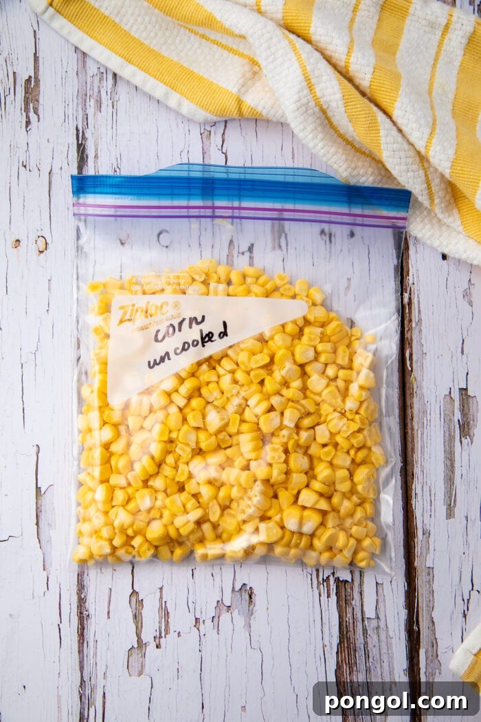 Uncooked corn kernels in a transparent freezer bag, showing their fresh state.