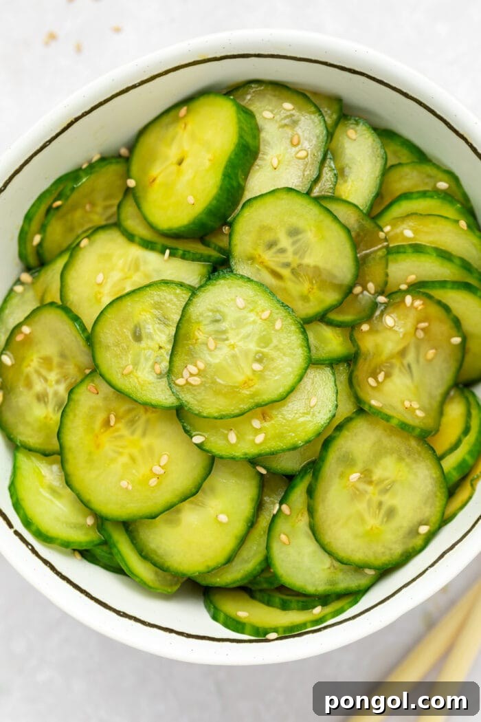 overhead image of japanese cucumber salad in a bowl with sesame seeds