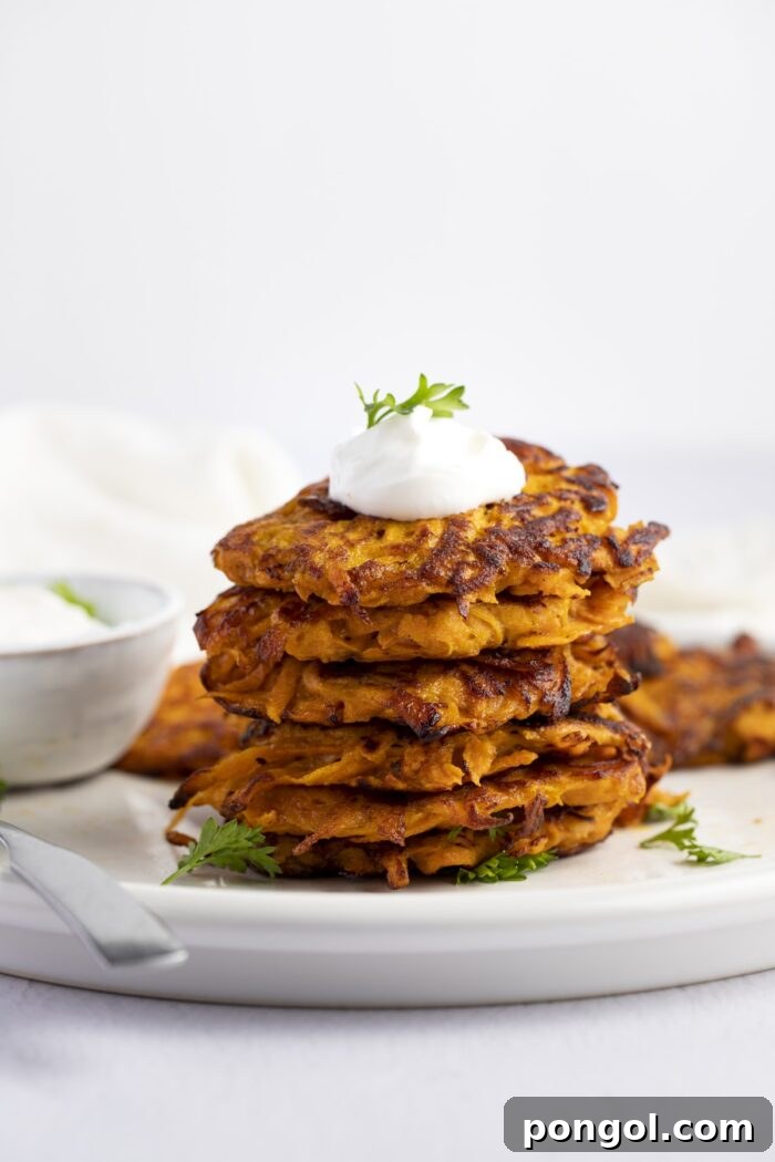 Stack of golden-brown sweet potato hash browns, perfectly crispy on the outside