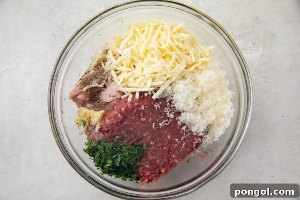 Ingredients for keto meatballs in a large glass bowl