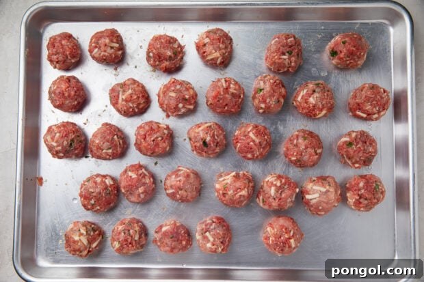 Rolled, uncooked keto meatballs on baking sheet