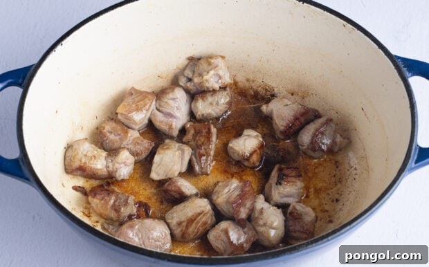 Pork chunks in neutral oil in dutch oven