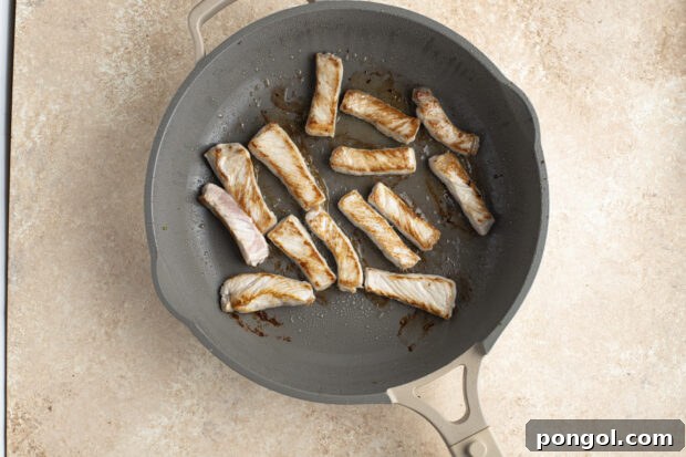 Pork strips in large skillet