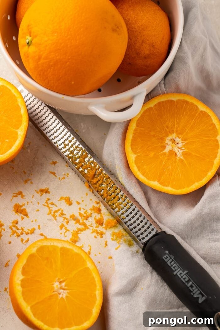 Oranges with orange zest and a microplane grater