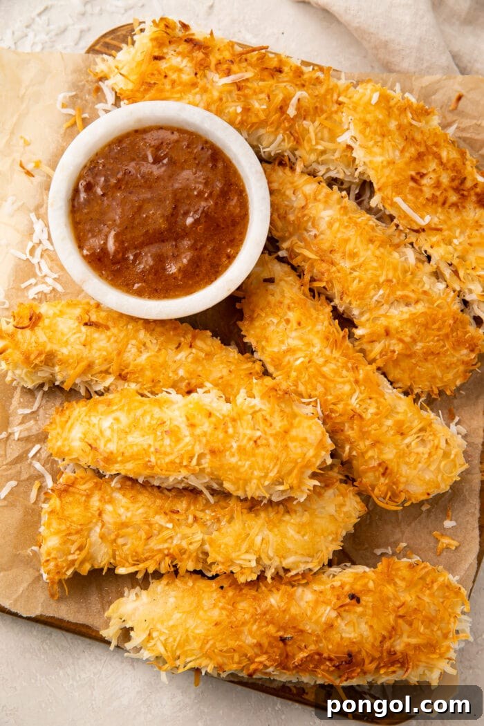 Golden Coconut Chicken with a Zingy Orange-Horseradish Glaze 3 A platter of coconut chicken with a small bowl of orange-horseradish sauce