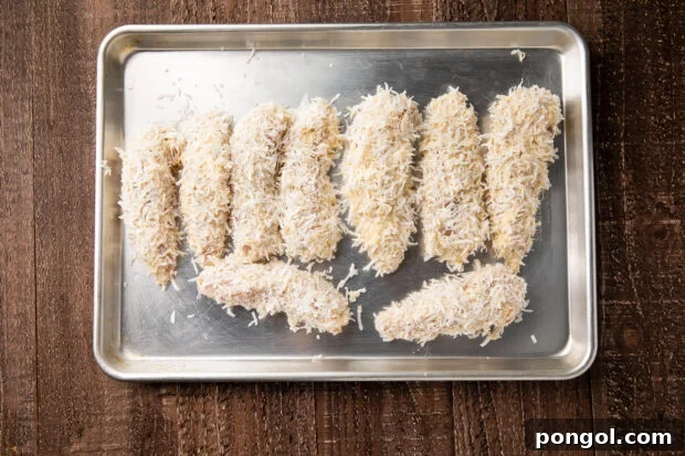 Golden Coconut Chicken with a Zingy Orange-Horseradish Glaze 8 Battered coconut chicken strips on baking sheet
