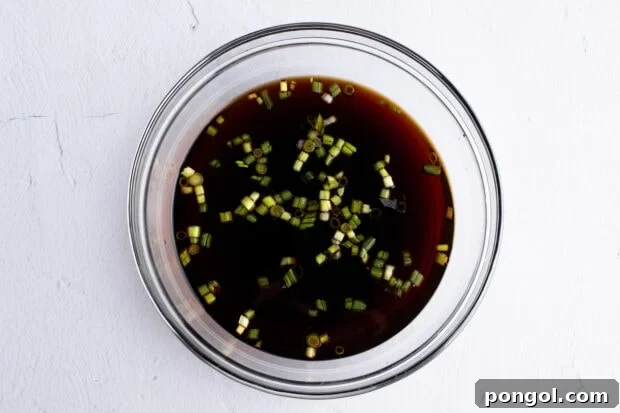 Sauce for shoyu chicken in medium glass bowl