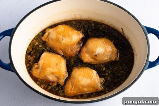 Chicken thighs in dutch oven with shoyu chicken sauce