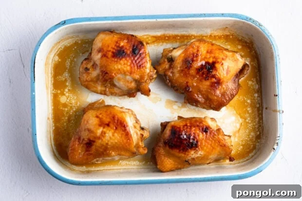 Cooked chicken thighs in baking dish