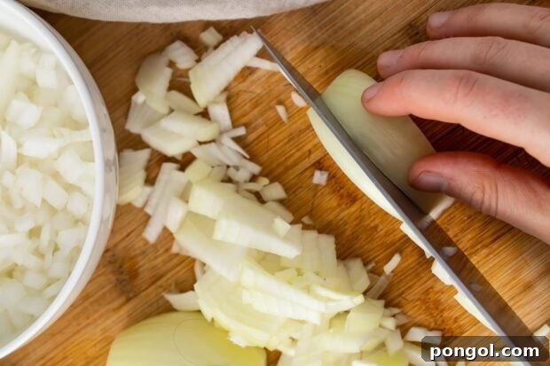 Slice attached side of onion into half inch wide strips