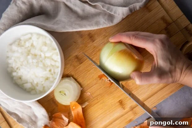 Slice the ends off the onion with a sharp knife