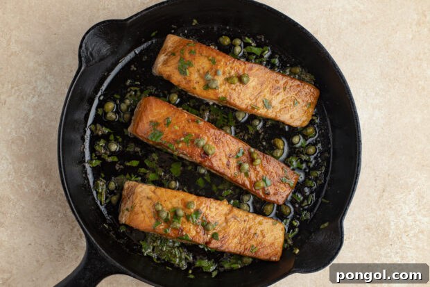 Salmon meuniere with capers in cast iron skillet