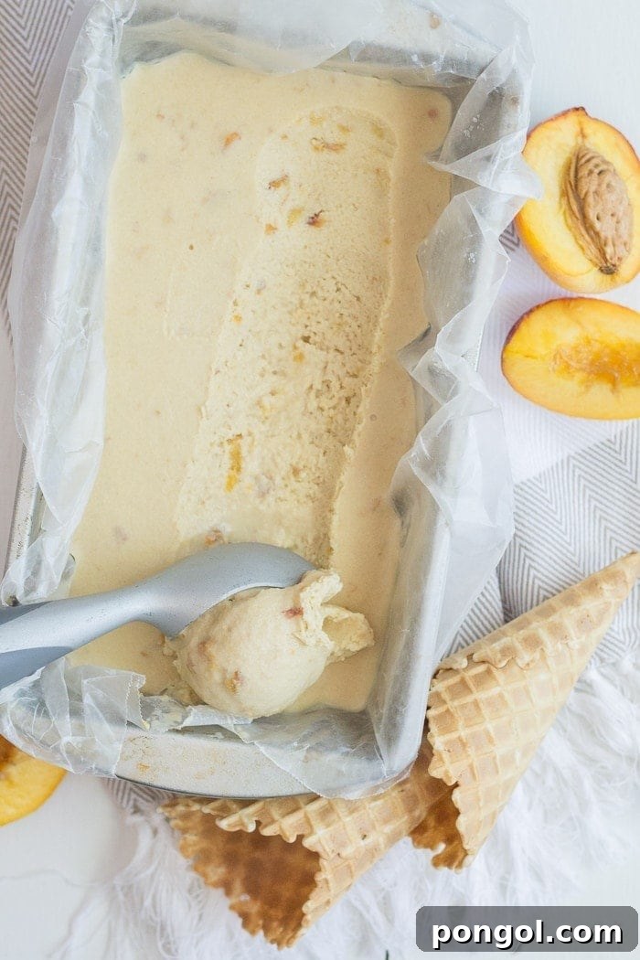 Sun-Kissed Vegan Peach Bliss 4 A scoop of homemade vegan peach ice cream melting slightly in a bowl, garnished with a fresh peach slice, highlighting its creamy texture.
