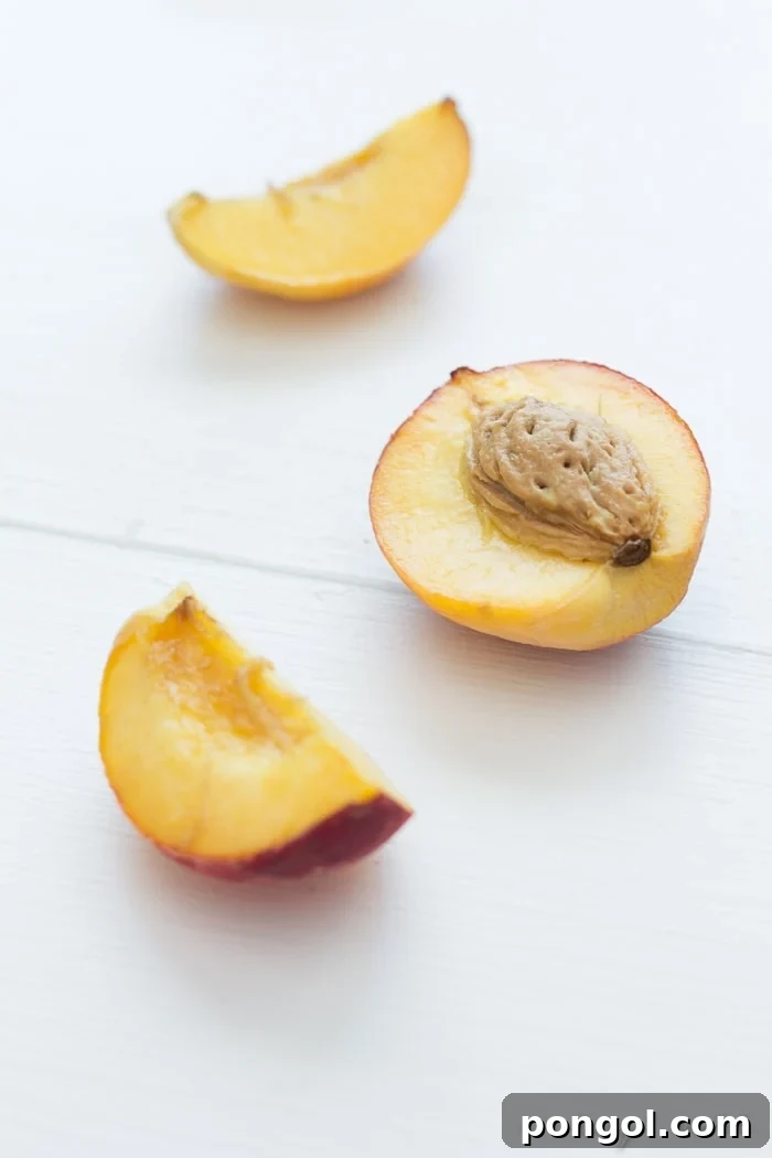 A bowl of creamy peach ice cream, showing the chunks of fresh peach embedded within the smooth base, tempting to taste.