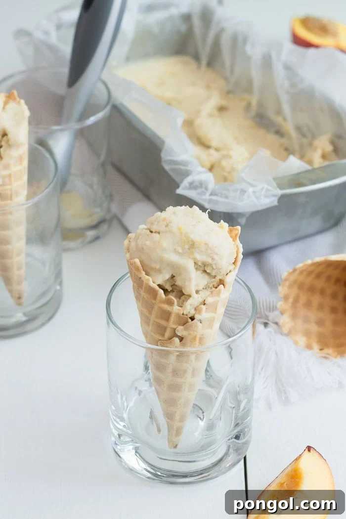 Sun-Kissed Vegan Peach Bliss 8 A generous scoop of vegan peach ice cream presented in a white bowl, ready to be served, emphasizing its homemade appeal.