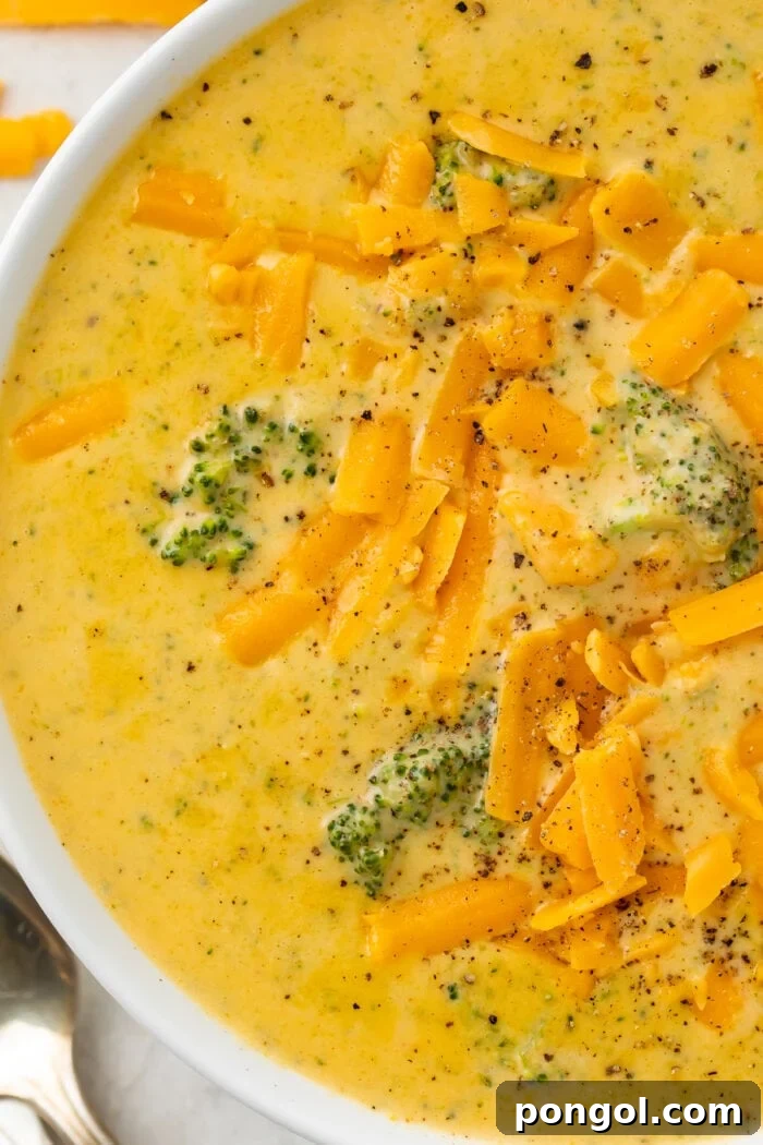 Close up of keto broccoli cheese soup in a white bowl