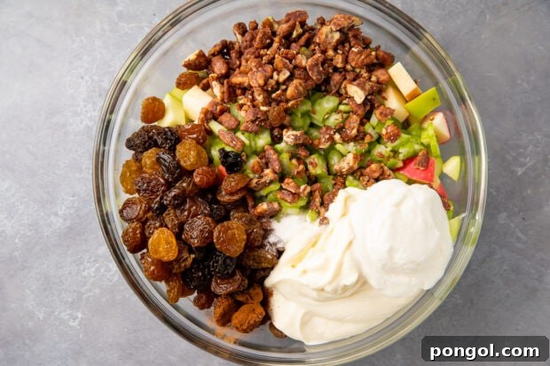 Ingredients for apple salad in large glass mixing bowl