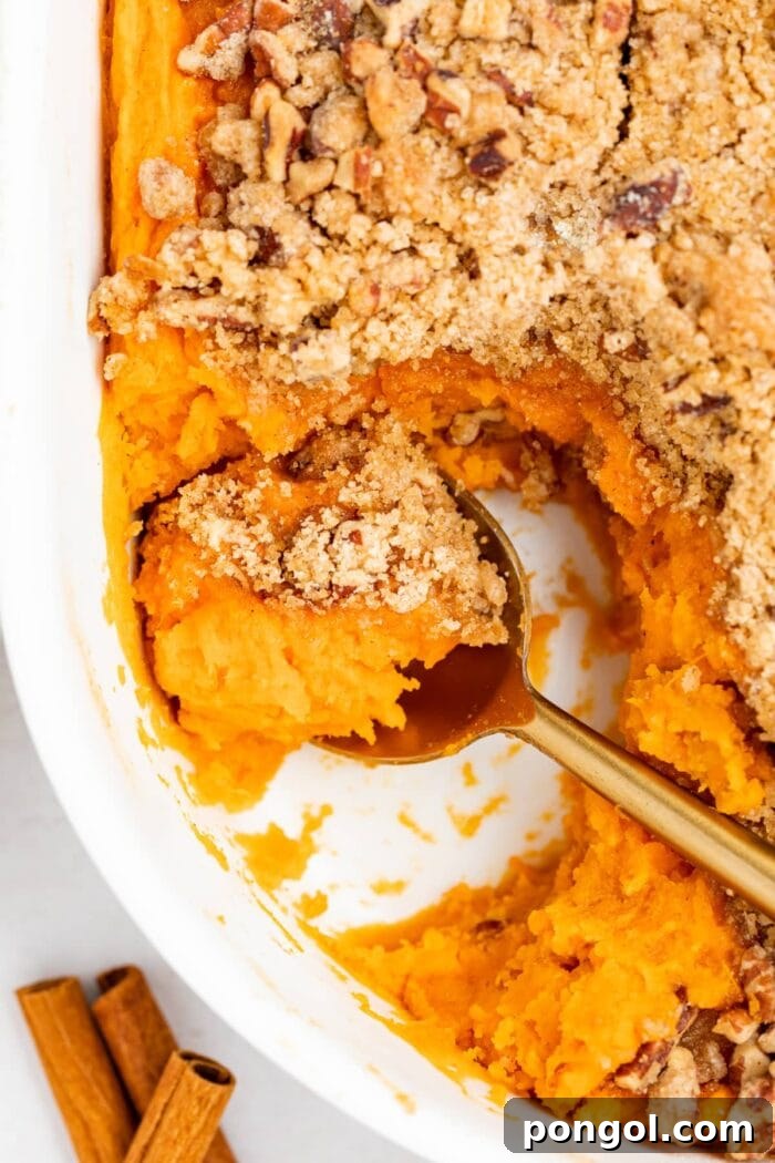 close up overhead image of sweet potato souffle with a spoon in it