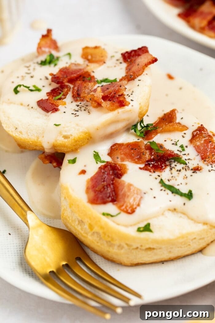 Crispy Pork Pan Gravy 2 bacon gravy on biscuits with bacon pieces and chopped parsley on top