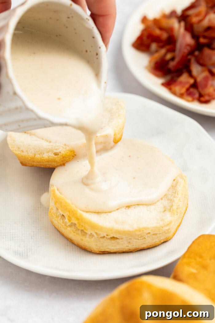Crispy Pork Pan Gravy 3 bacon gravy being poured over biscuits on a plate