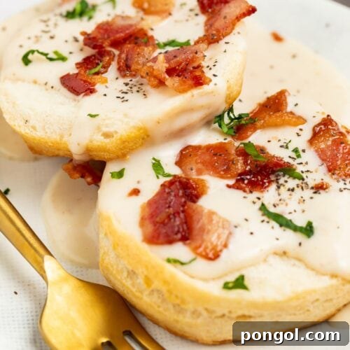 Crispy Pork Pan Gravy 4 bacon gravy on biscuits with bacon pieces and chopped parsley on top