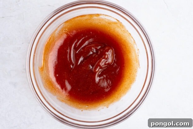 Glaze for bacon wrapped meatloaf in glass mixing bowl