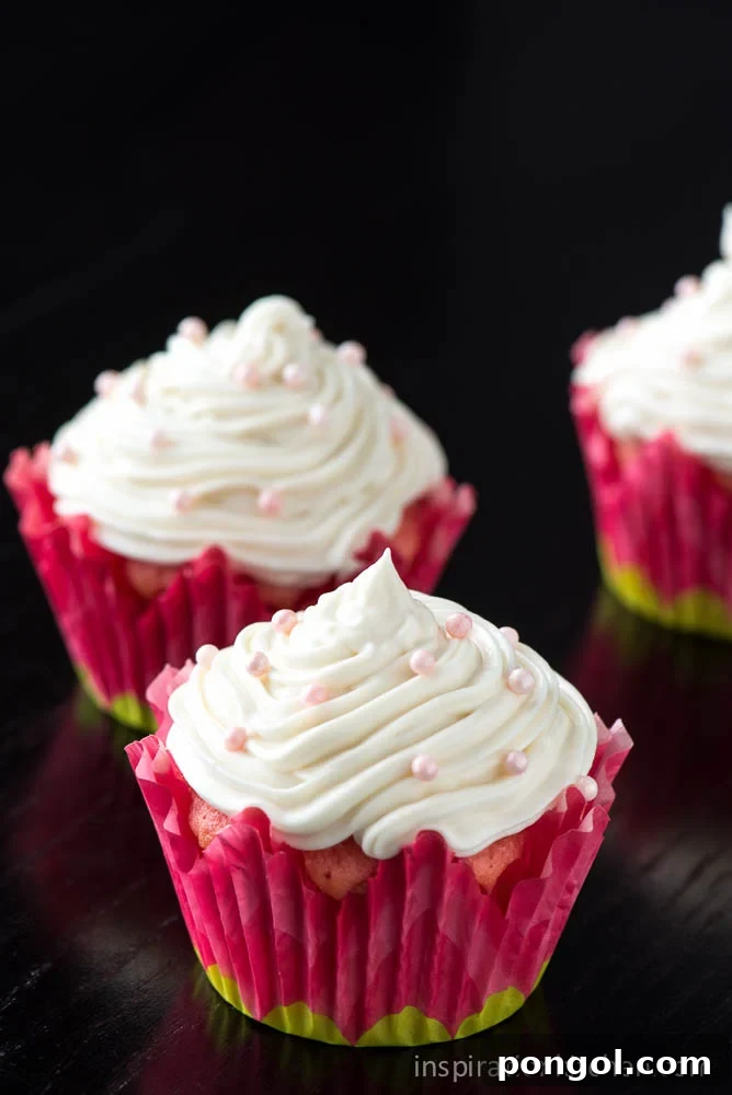 Sweet Strawberry Cupcakes crowned with luscious Cream Cheese Frosting, an ideal dessert for celebrations
