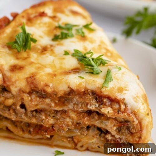 Close up view of a slice of Instant Pot lasagna on a white plate