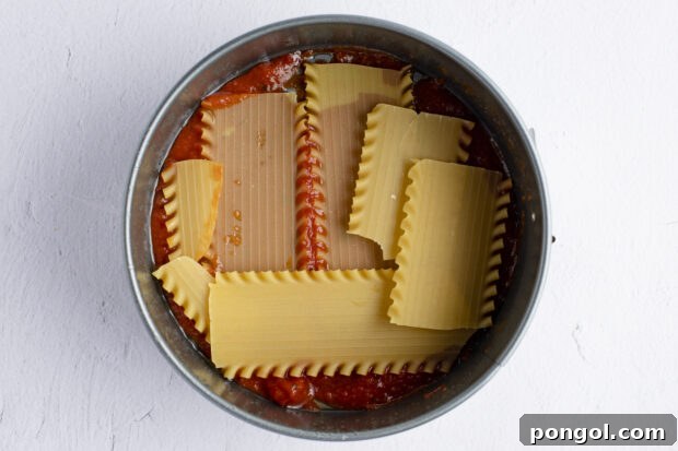 Bottom layer of lasagna in springform pan