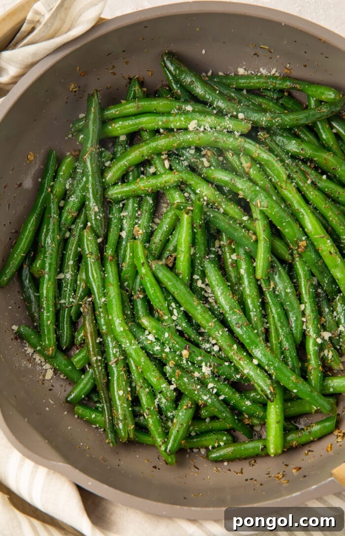 Italian green beans artfully arranged in a large grey bowl, garnished with herbs.