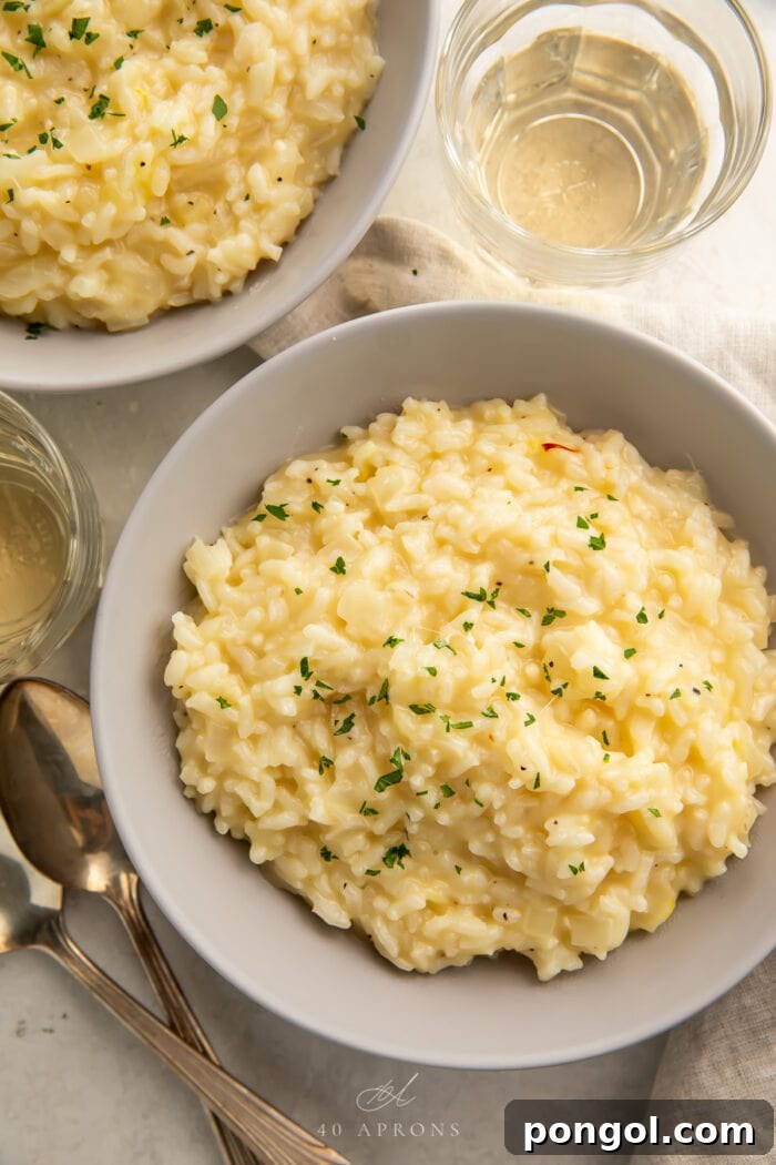 Overhead angle of two bowls of Instant Pot risotto garnished with fresh herbs