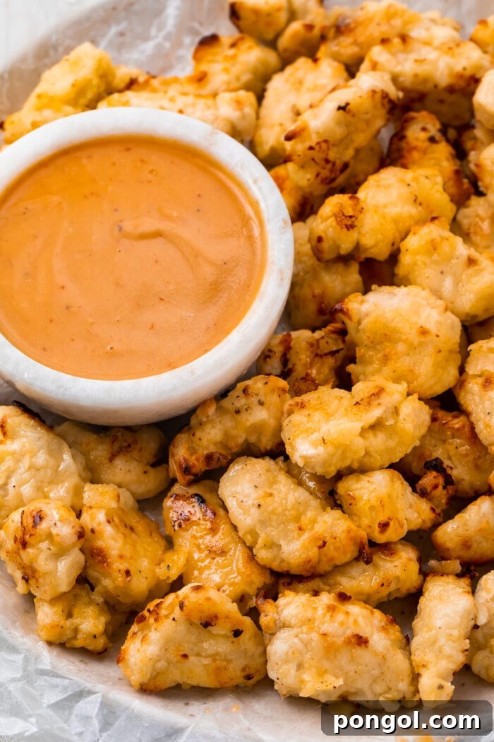 Air fryer chicken nuggets next to a bowl of Chick-fil-a sauce