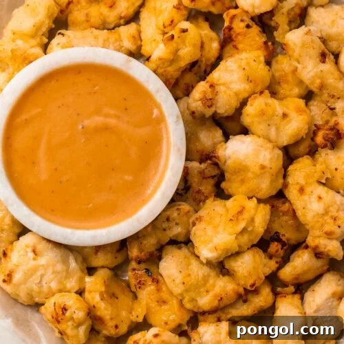 Air fryer chicken nuggets next to a bowl of Chick-fil-a sauce