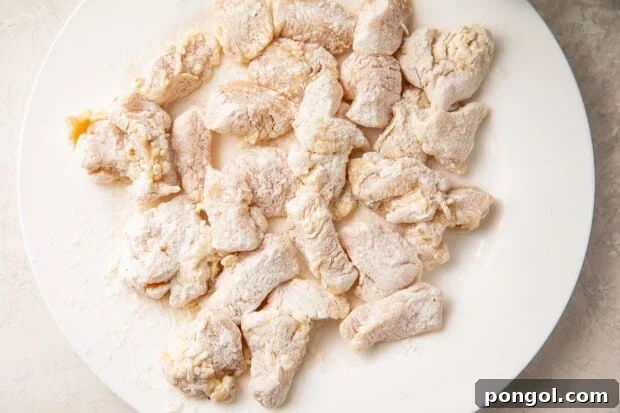 Flour-coated chicken pieces on a plate